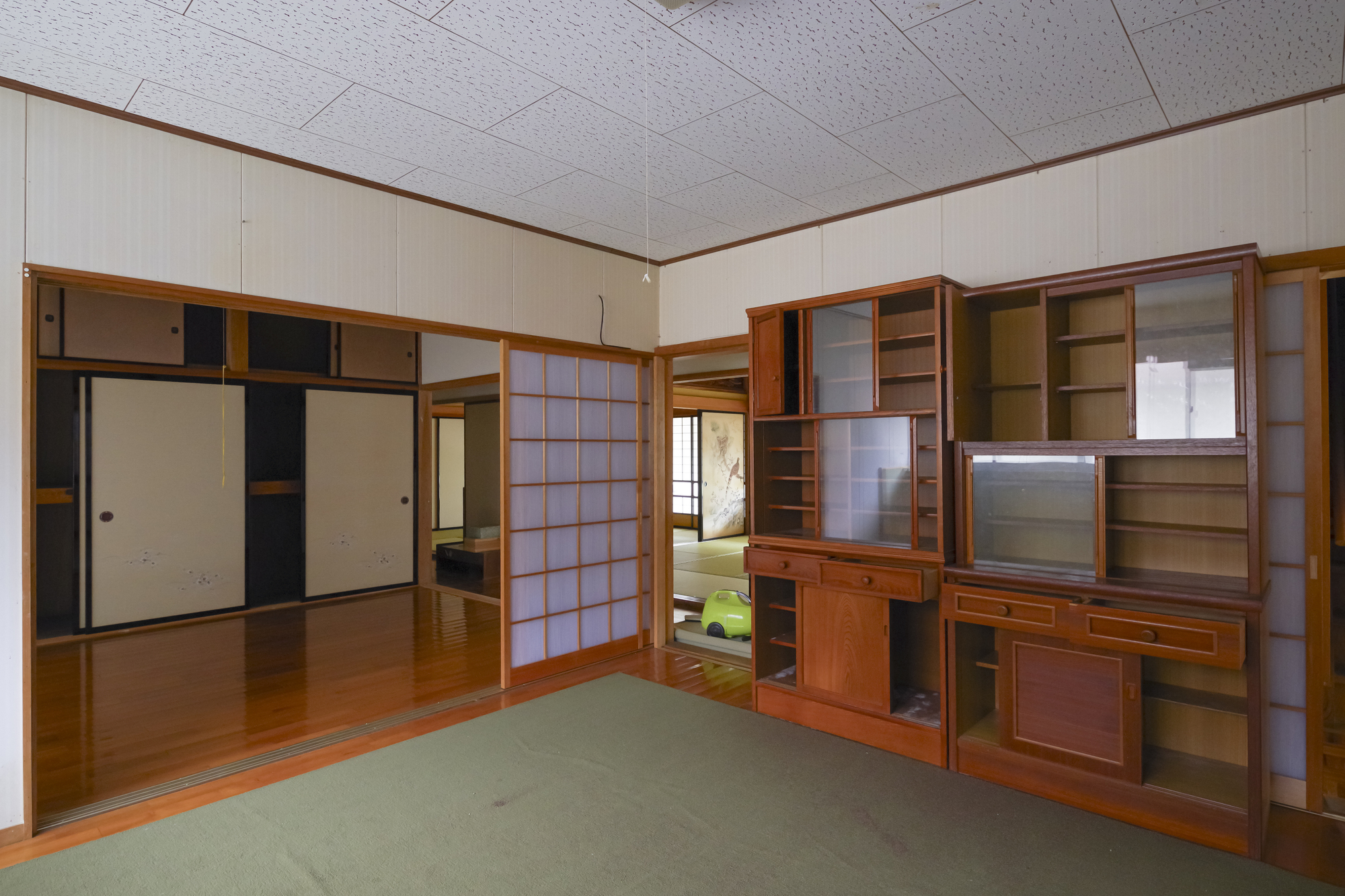 家具や古いテレビが残されたままの、誰も住んでいない家の和室